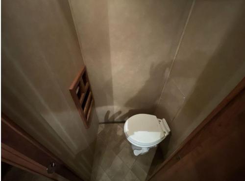 a small bathroom with a toilet in a room at LOVELY RV in Dallas