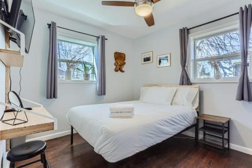 a bedroom with a bed and two windows at 3BD Family Friendly Walk to Huston Lake in Denver