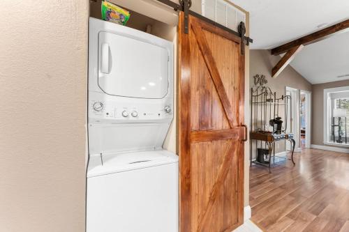 a kitchen with a washer and dryer next to a door at Penthouse Thousand Hills Golf Front Condo with Pool close to 76 and Sleeps 8 in Branson