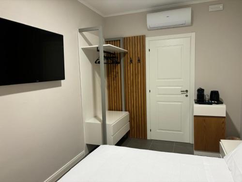 a bedroom with a bed and a tv on a wall at Camere di Bianca in Foligno
