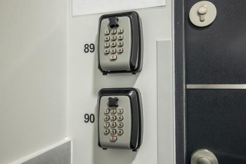 an elevator with a door with the numbers on it at WiguryTower Apartaments 71' in Łódź