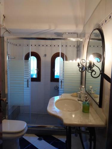 a bathroom with a sink and a shower and a toilet at Stunning Evia Sea View Country House in Roïdhítsa