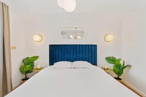 a bedroom with a large bed with a blue headboard at Chic Apt Close to Kirchberg Shopping Centre ID157 in Luxembourg
