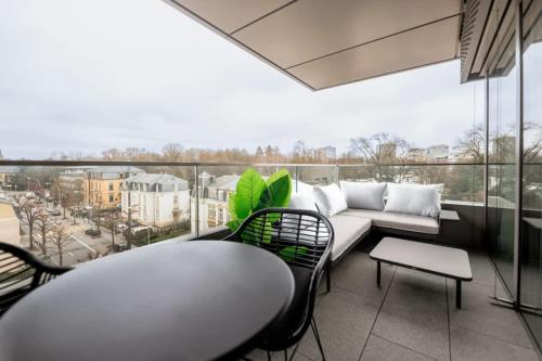 a living room with a couch and a large window at City Luxury with City Views in Ville Haute in Luxembourg