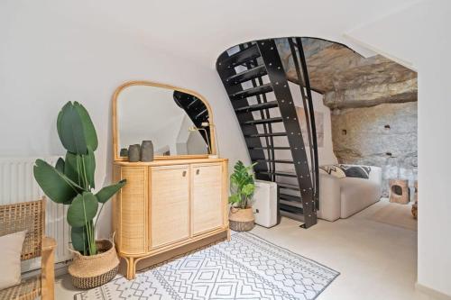 a room with a mirror and a dresser and a couch at Elegant 1BR Retreat in Peaceful Grund in Luxembourg