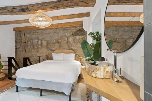 a bedroom with a bed and a desk with a mirror at Elegant 1BR Retreat in Peaceful Grund in Luxembourg