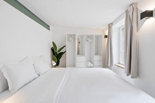 a white bedroom with a large bed and windows at Modern Apt in Old Town w Panoramic View ID4 in Luxembourg