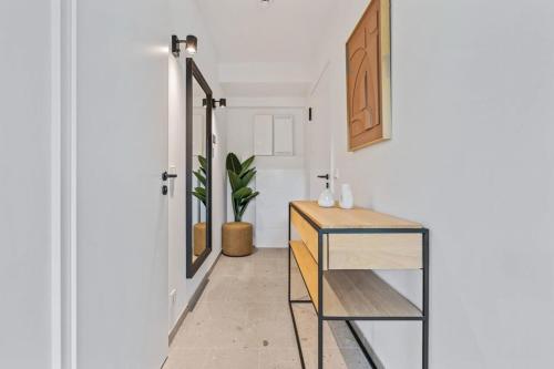 a hallway with a glass cabinet and a potted plant at Clausen Serenity Cozy Apt ID208 in Luxembourg