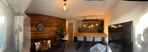 a living room with a counter and a kitchen at Chalet Martin Belle-Vue in Aime-La Plagne