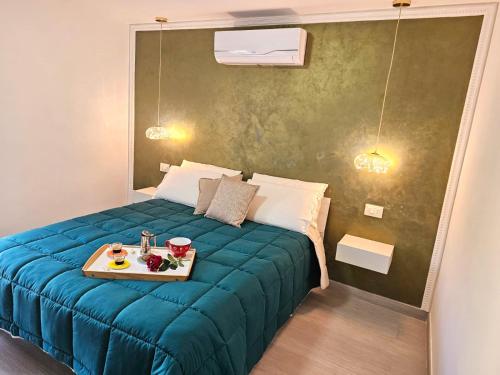 a bedroom with a bed with a tray of food on it at Casa Semeria Certosa di Padula(SA) in Padula