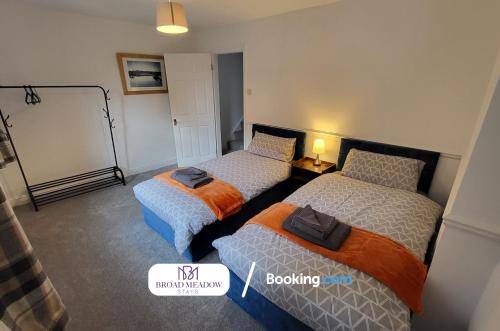 a bedroom with two beds and a chalkboard at 3 Bedroom House By Broad Meadow Stays Short Lets and Serviced Accommodation Lincoln With Parking in Lincoln