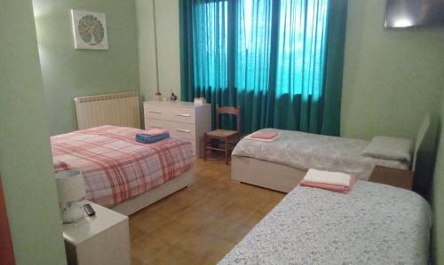 ein kleines Schlafzimmer mit 2 Betten und einer Kommode in der Unterkunft Affittacamere al picchio verde in Monsampietro Morico