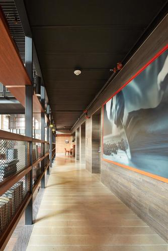 a hallway in a building with paintings on the walls at The Artisan D.C. Hotel, Autograph Collection in Bogotá