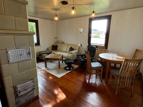 a living room with a couch and a table at Strand und Waldhaus in Ückeritz Uriges Ambiente trifft Meer in Ueckeritz