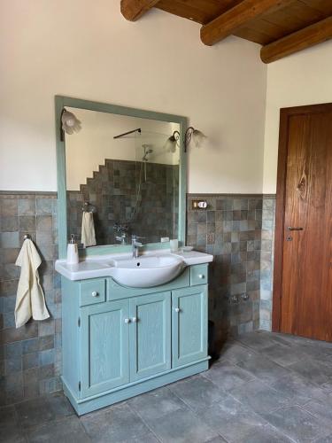 a bathroom with a blue sink and a mirror at B&B Casa Contento in Arcevia