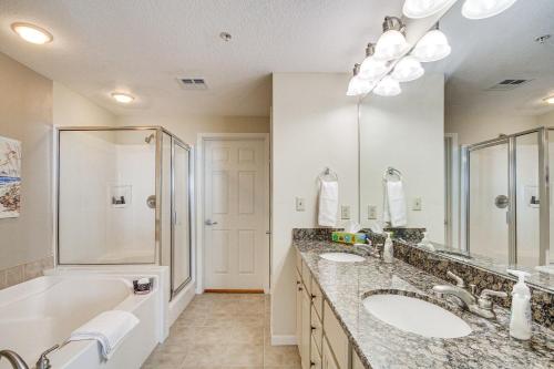 a bathroom with two sinks and a shower at Charming Condo on the Beach/Legacy T2-1102 in Gulfport