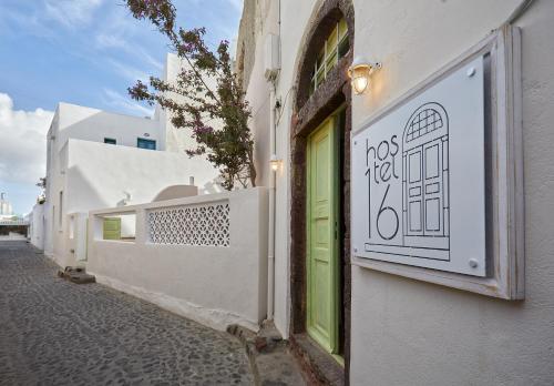 a building with a door and a sign on it at Hostel 16 Oia in Oia