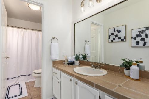 a bathroom with a sink and a toilet and a mirror at Scottsdale - 15035 N 54th St in Phoenix
