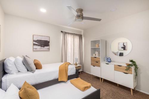 a bedroom with two beds and a mirror at Scottsdale - 15035 N 54th St in Phoenix