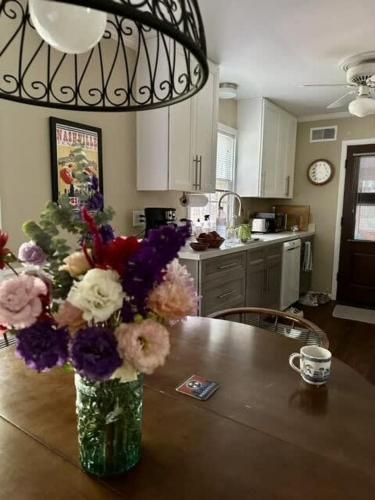 a vase of flowers on a table in a kitchen at Nashville Elegance Enjoy Southern Comfort in Style in Nashville