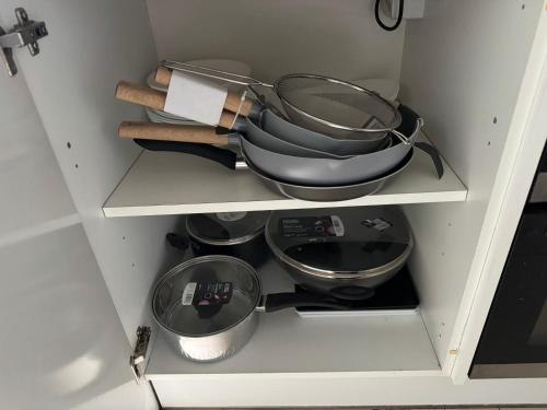 a cupboard filled with pots and pans at HANDOVER 2 in London