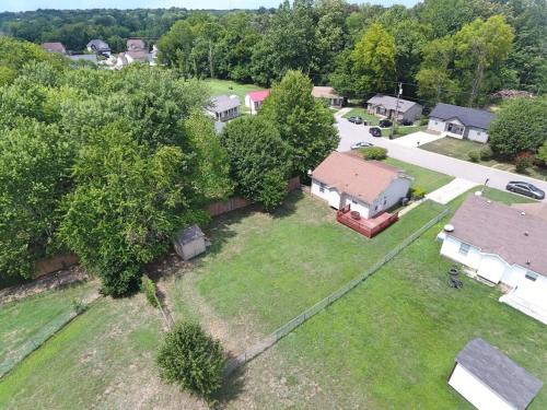 an aerial view of a house with a yard at Beautiful cul-de-sac home with a fenced in yard! in Clarksville