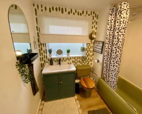 a small bathroom with a sink and a window at K Suites - Park Grange Croft in Sheffield