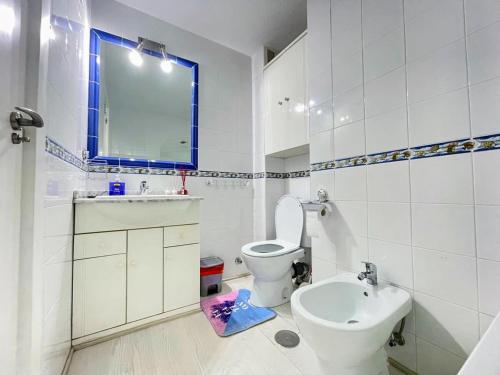 a white bathroom with a toilet and a sink at Modernized 2 Bed Apt with Com pool PP27 in Torrevieja