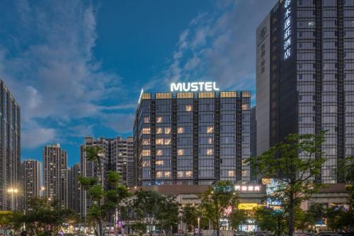 a building with a mustisel sign on top of it at MUSTEL Hotel Guangzhou Nansha in Guangzhou