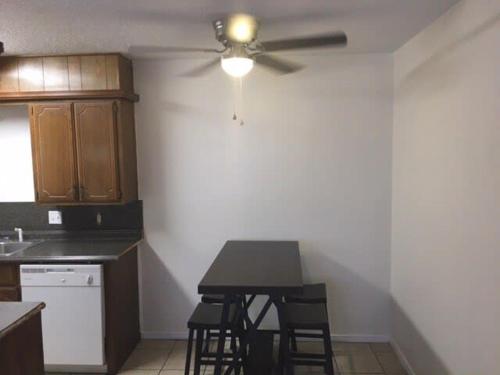 a kitchen with a ceiling fan and a table with chairs at One bedroom close to Fort Sill! in Lawton