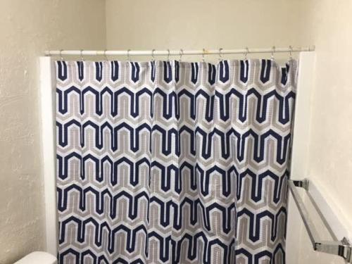 a shower curtain in a bathroom with a toilet at Cozy 1-BR upstairs apartment, near Fort Sill! in Lawton