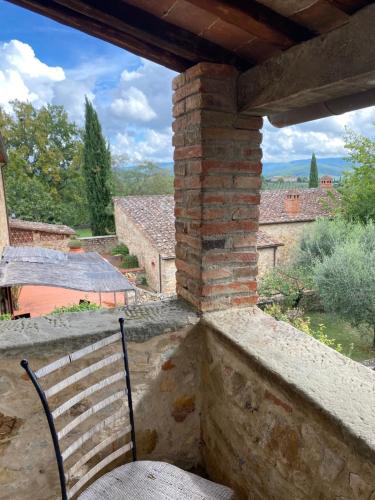 a bench sitting on a porch with a view of the countryside at Tenuta Lupinari in Bucine