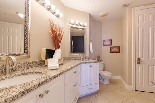 a bathroom with a sink and a toilet at Gulf Front Condo Outdoor Pool & Grill 608 in Orange Beach