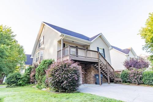 a large house with a staircase in front of it at Cozy Pigeon Forge home w hot tub near river in Pigeon Forge