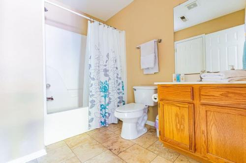 a bathroom with a toilet and a shower and a sink at Cozy, comfortable Pigeon Forge home close to all attractions and beautiful river in Pigeon Forge