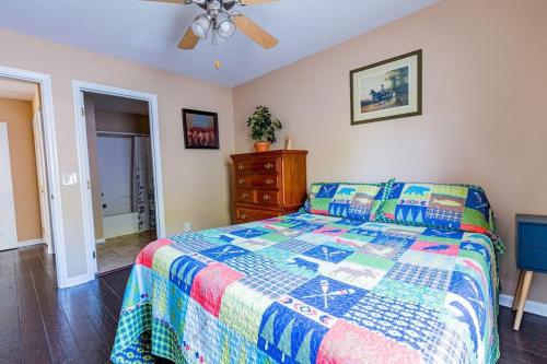 a bedroom with a bed and a ceiling fan at Cozy, comfortable Pigeon Forge home close to all attractions and beautiful river in Pigeon Forge