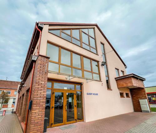 a building with glass doors on the side of it at Keta in Marijampolė
