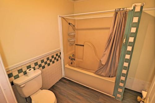 a small bathroom with a toilet and a shower at A simple and functional space for travelers in Knoxville