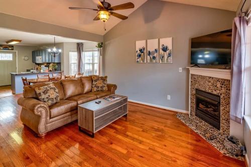 a living room with a couch and a fireplace at Home near all Sevier County attractions! in Pigeon Forge