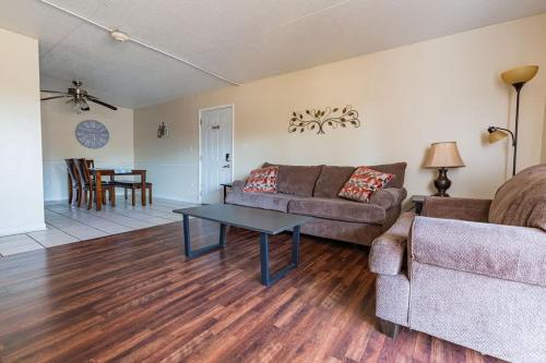 a living room with a couch and a table at 2-bed, 2-bath apartment living experience in Chattanooga