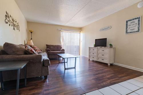a living room with a couch and a tv at 2-bed, 2-bath apartment living experience in Chattanooga