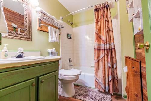 a bathroom with a toilet and a sink and a shower at Genuine log cabin minutes away from Chattanooga's top attractions in Chattanooga