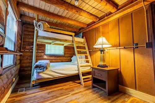 a bedroom with bunk beds in a log cabin at Genuine log cabin minutes away from Chattanooga's top attractions in Chattanooga