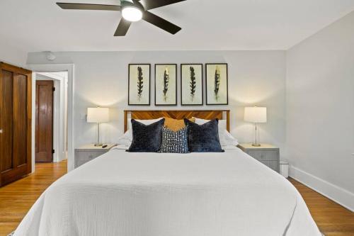a bedroom with a large white bed with a ceiling fan at Rochester Gem: 3BR Near All! in Rochester