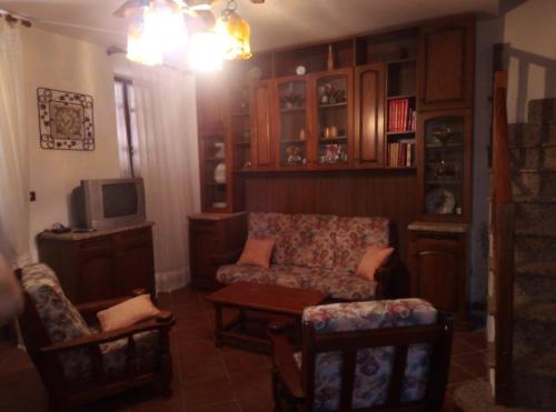 a living room with a couch and a tv at Casa Portopaglia in Gonnesa