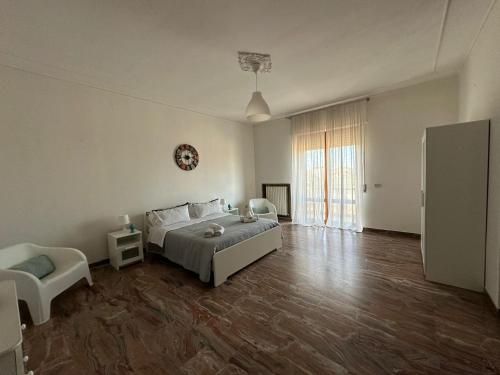 a bedroom with a bed and a chair in it at La casa di Stefania vista mare in Francavilla al Mare