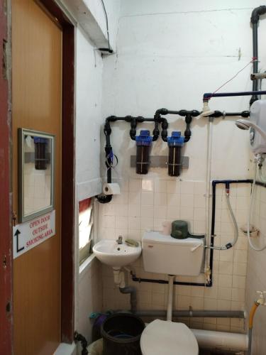 a bathroom with a toilet and a sink at WISMA ORCHID HOMESTAY Tuaran in Tuaran