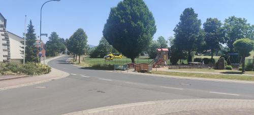 an empty road with trees and a playground at Landhaus Rhönblick in Künzell