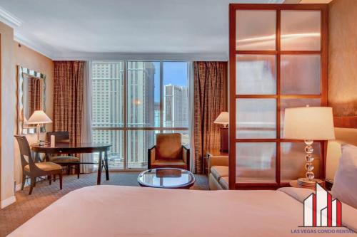 a hotel room with a bed and a large window at MGM Signature 15-603 Strip View Jacuzzi Studio in Las Vegas