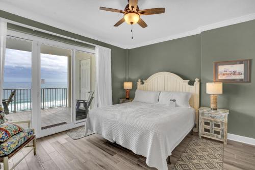 a bedroom with a bed and a balcony at Regency Isle 911 in Orange Beach